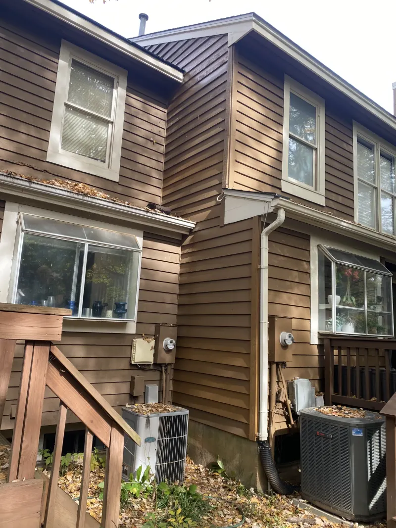 Completed cedar siding restoration with seamless repair